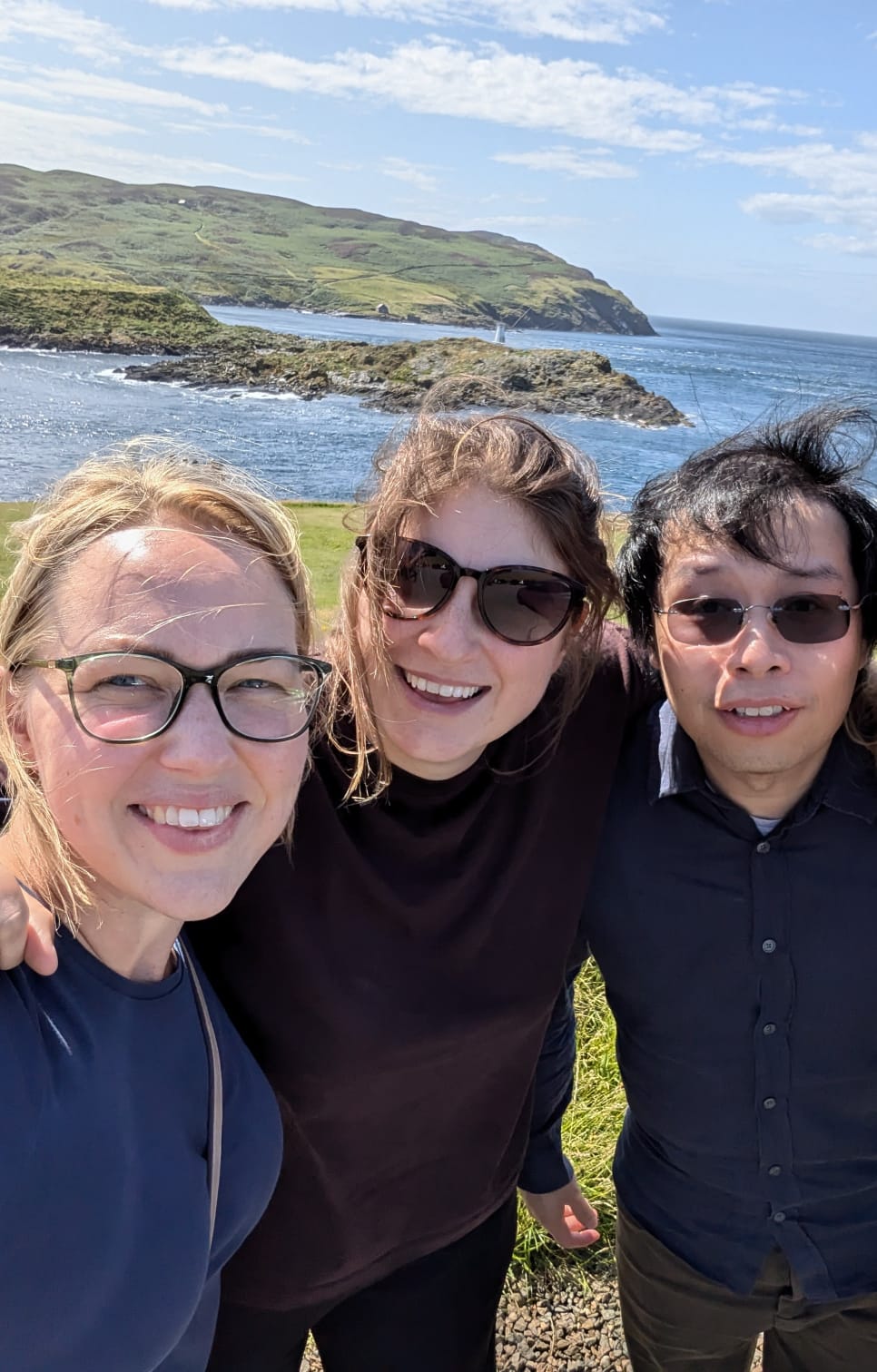 Three people having their picture taken in the Isle of Man